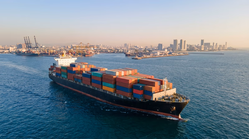 An illustrated cargo ship on the ocean with containers labeled with different country flags, showing global trade in action